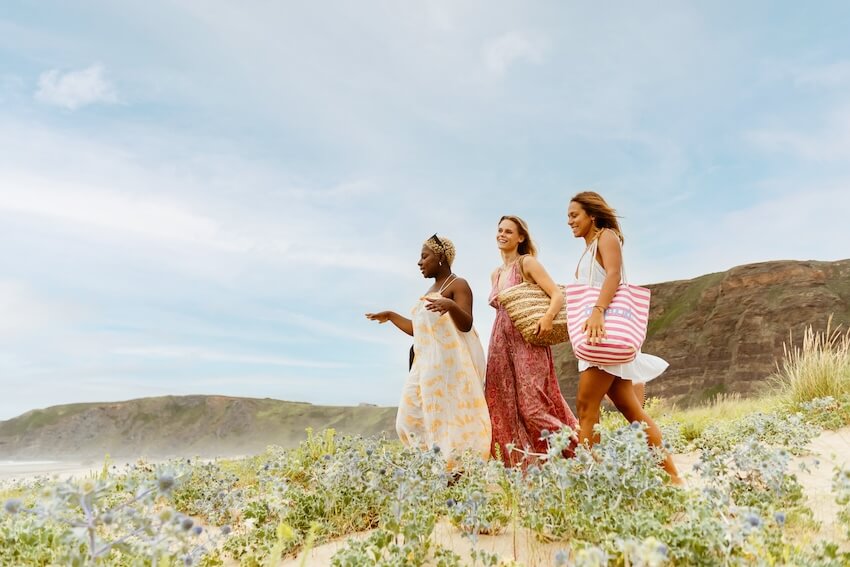 3 women happily walking together