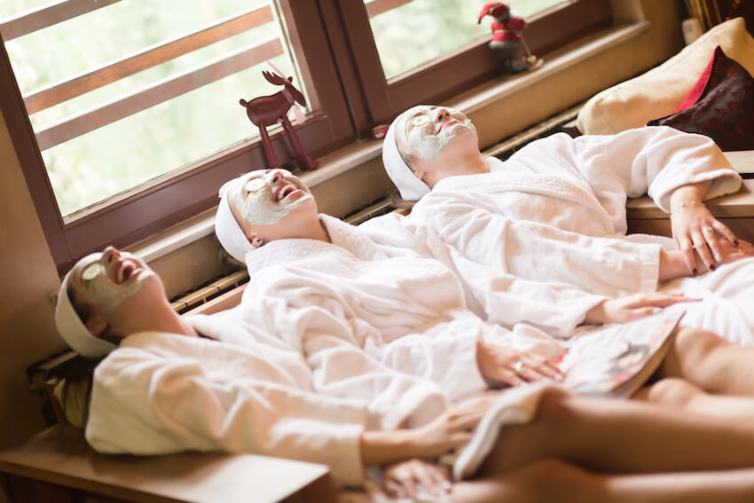 Spa birthday party: 3 women with clay masks, happily relaxing at the spa