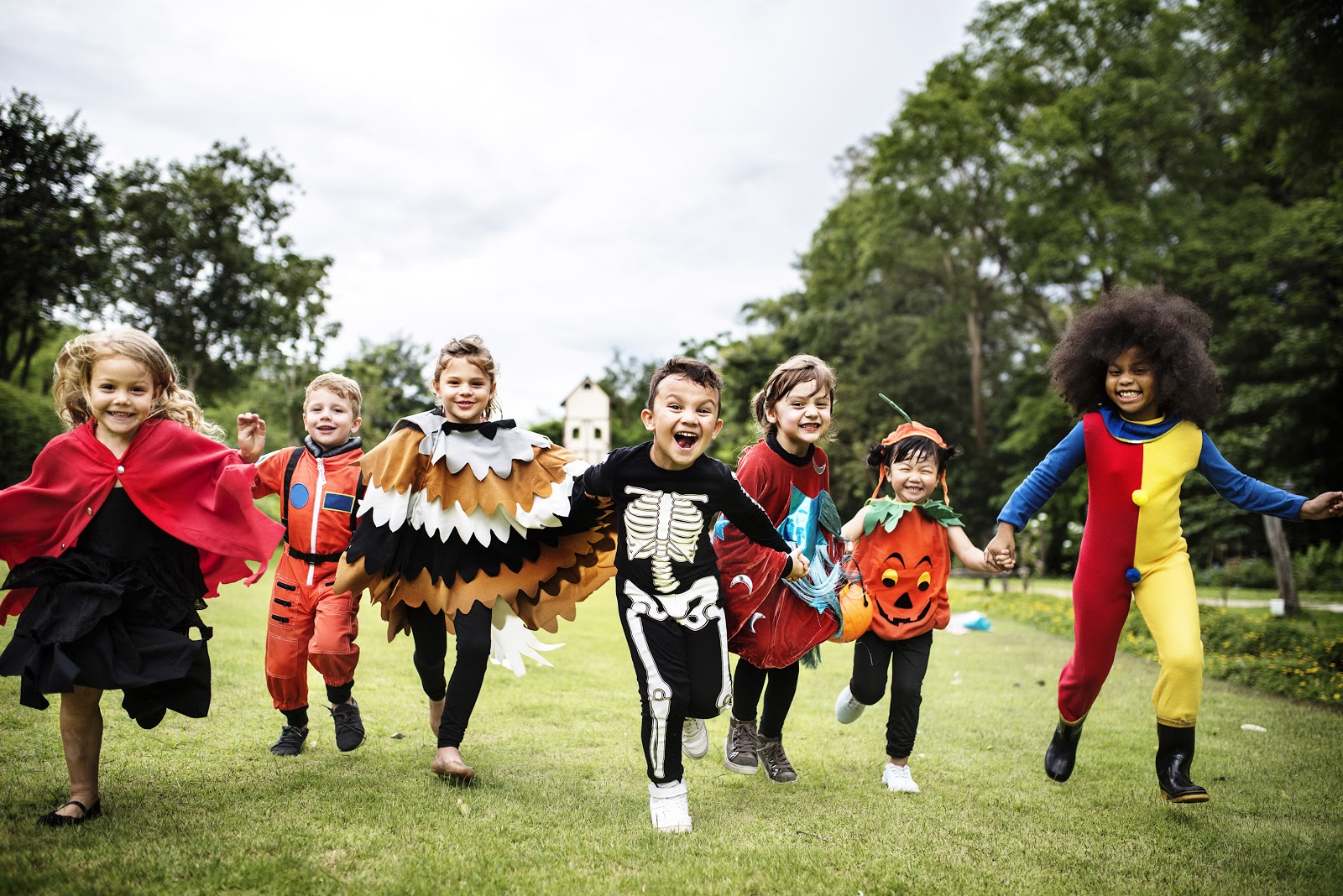 Kids play outside in their Halloween costumes