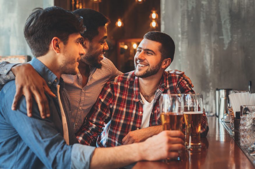 Bachelor party ideas: Three guy friends in an industrial pub