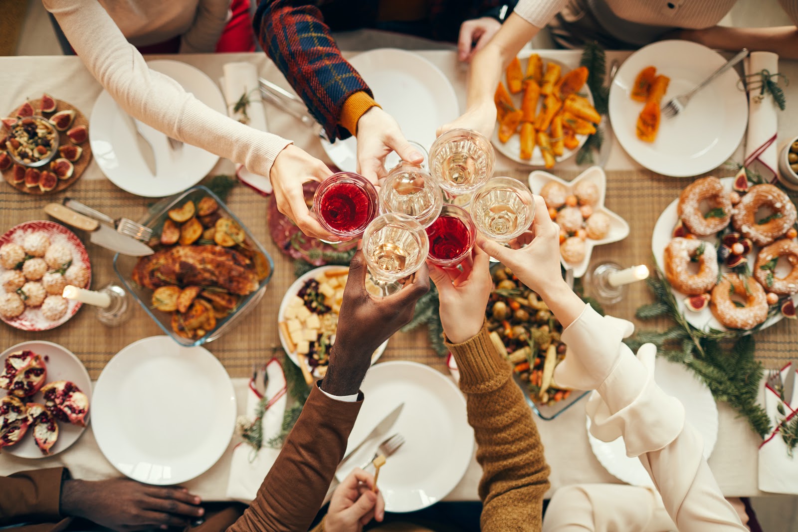 Christmas party food ideas: Guests raise their glasses over a Christmas party dinner table