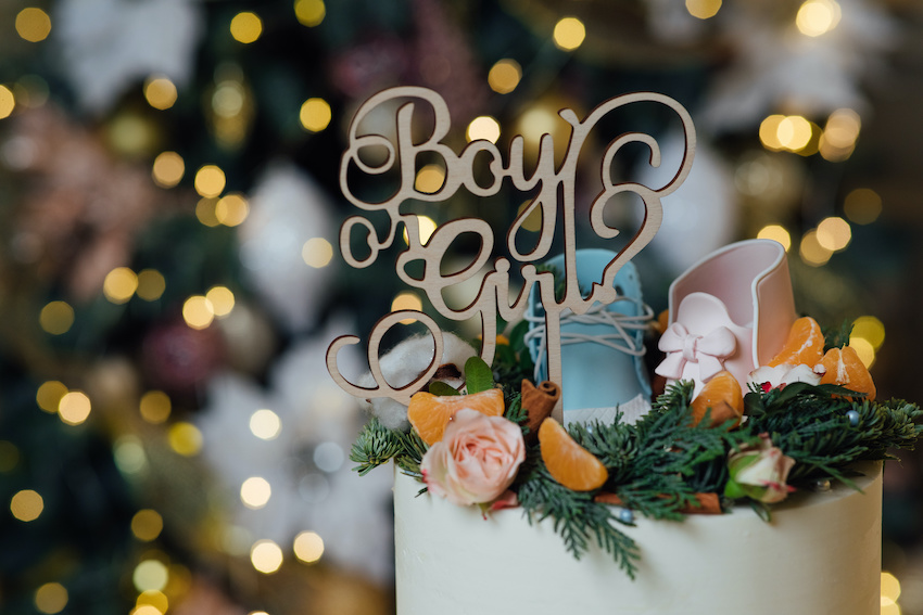 A baby shower cake with a cake topper that reads "Boy or Girl"