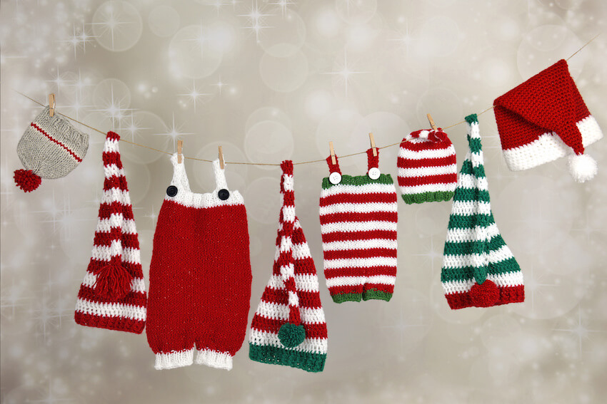 Winter pregnancy announcement: Christmas clothes hanging on a clothesline