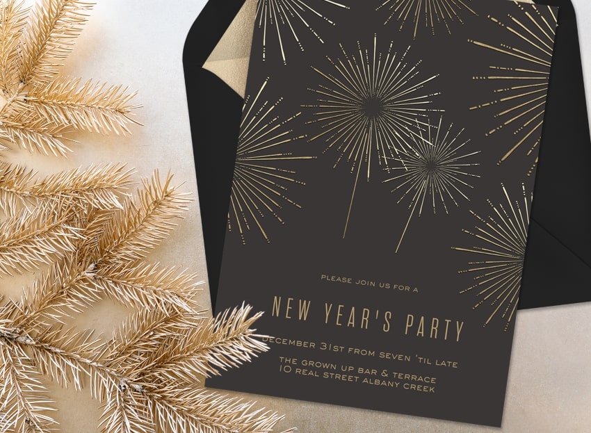 New Years party ideas: Shimmery Fireworks Invitation and dried pine branches beside it
