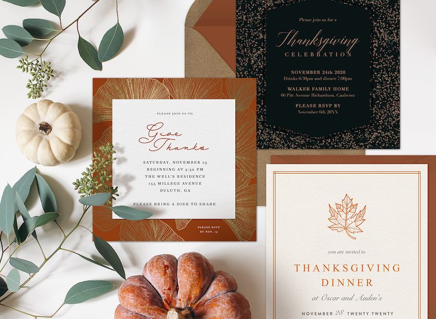 Three thanksgiving invitations surrounded by mini pumpkins and greenery