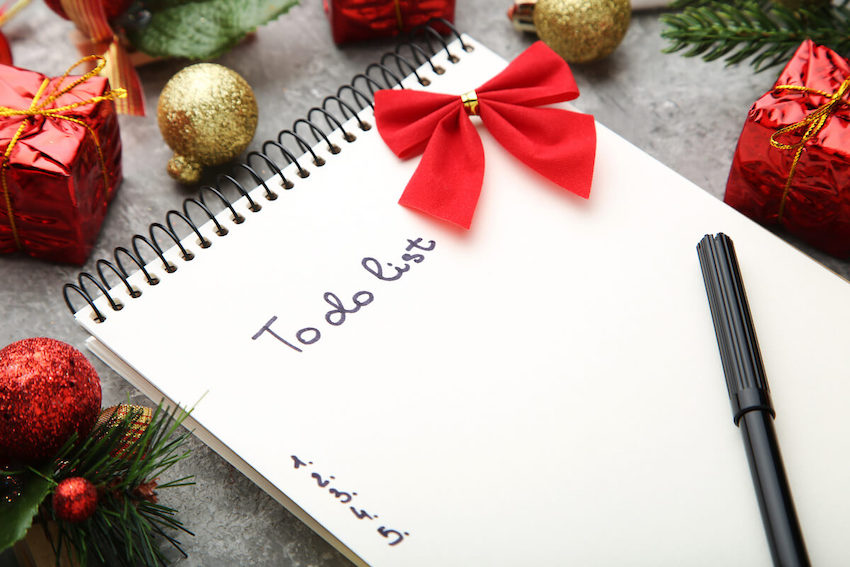 Ugly sweater party ideas: To do list for Christmas written on a notebook