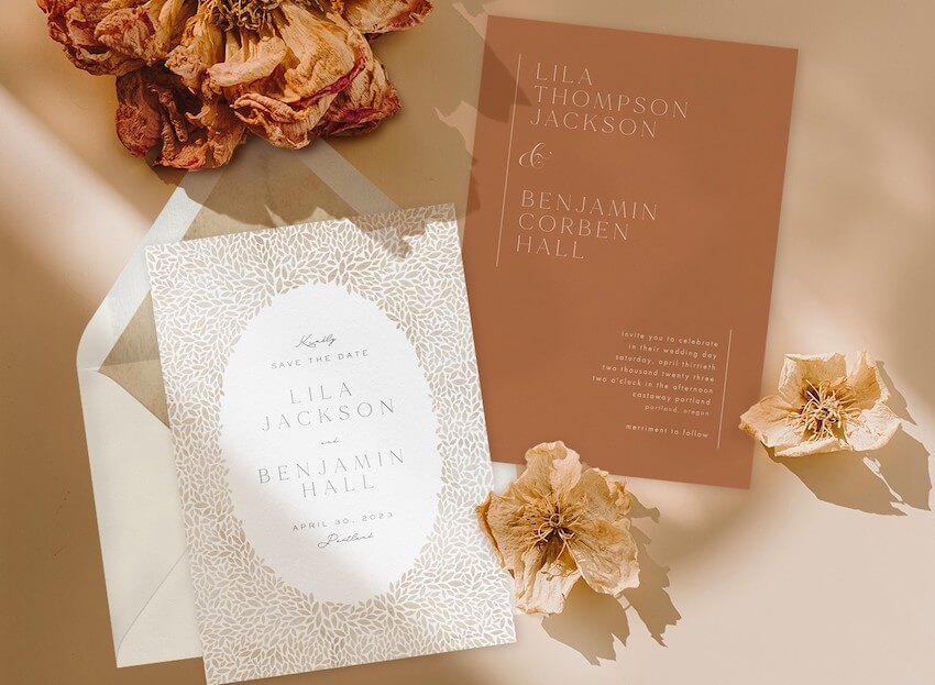 Wedding invitation etiquette: wedding invitations with flowers beside it