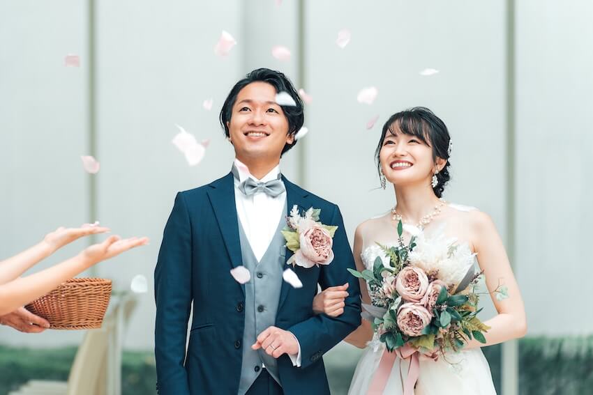 Asian couple showered with flower petals during their wedding