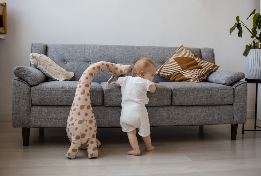 Baby playing with a giraffe stuffed toy