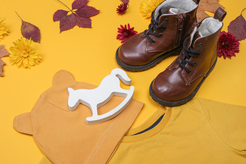 Baby shoes, shirt, hat, and a rocking horse toy