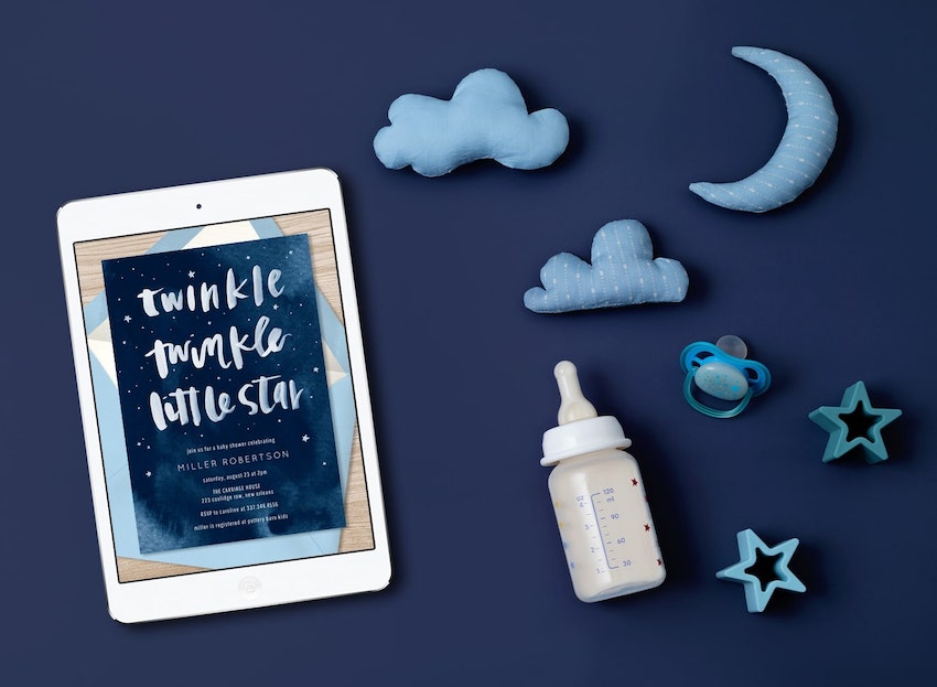 Twinkle twinkle little star baby shower: baby shower invitation on a tablet screen, a baby bottle, and a pacifier