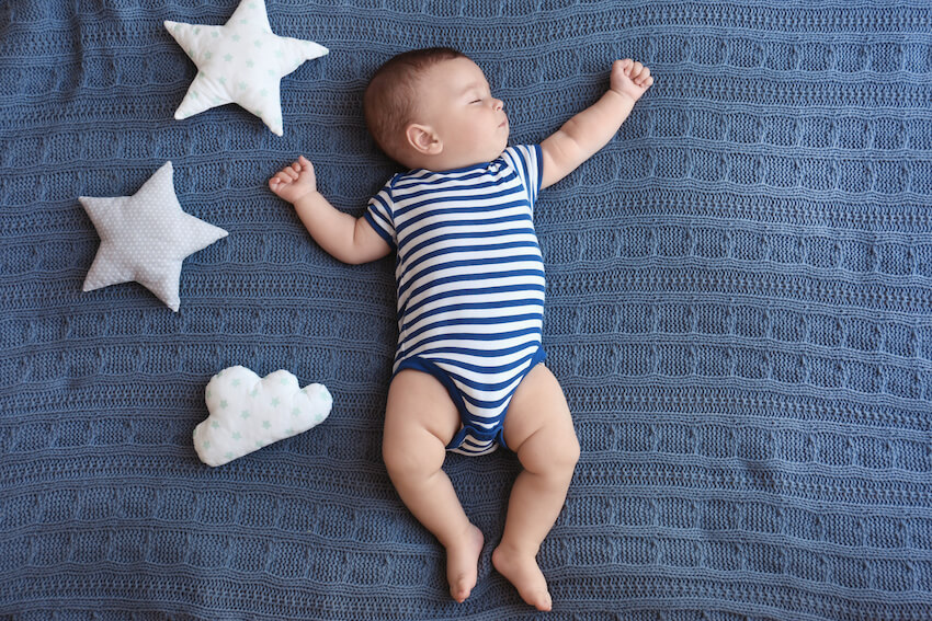 Twinkle twinkle little star baby shower: baby sleeping on a bed