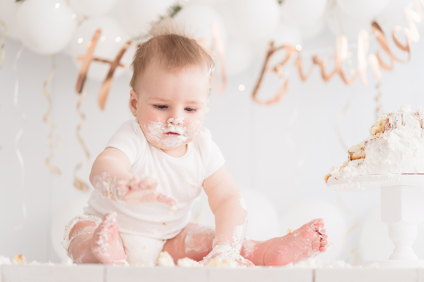 First birthday themes: baby smashing a cake