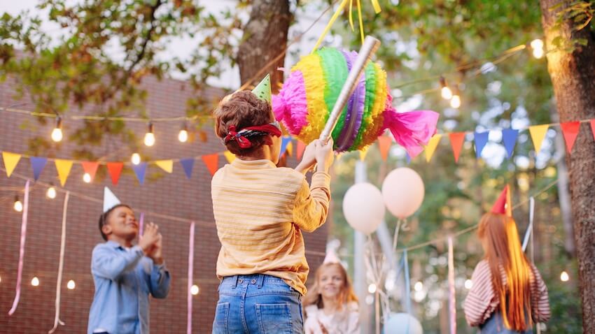 Blindfolded kid trying to hit a piñata