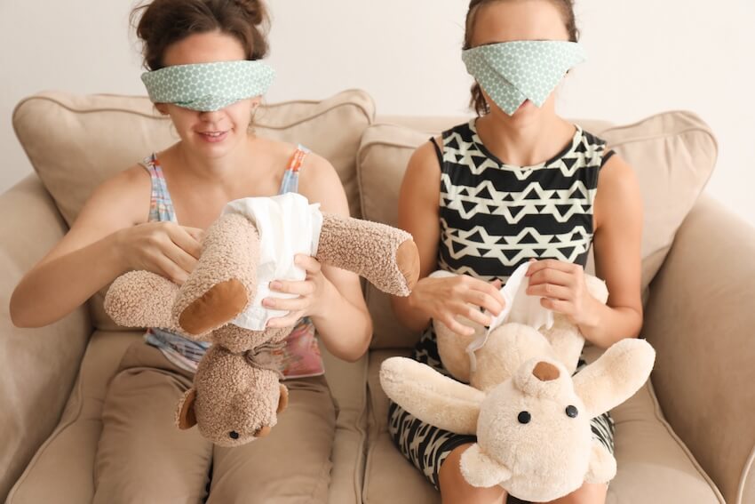 Unique baby shower games: blindfolded women putting diapers on teddy bears