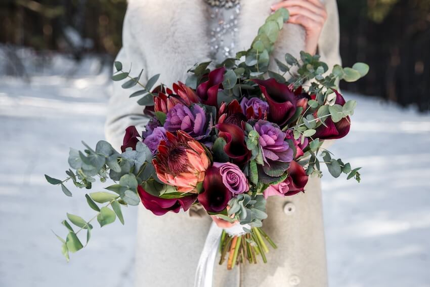 Wedding bouquet ideas: woman holding a bouquet of flowers