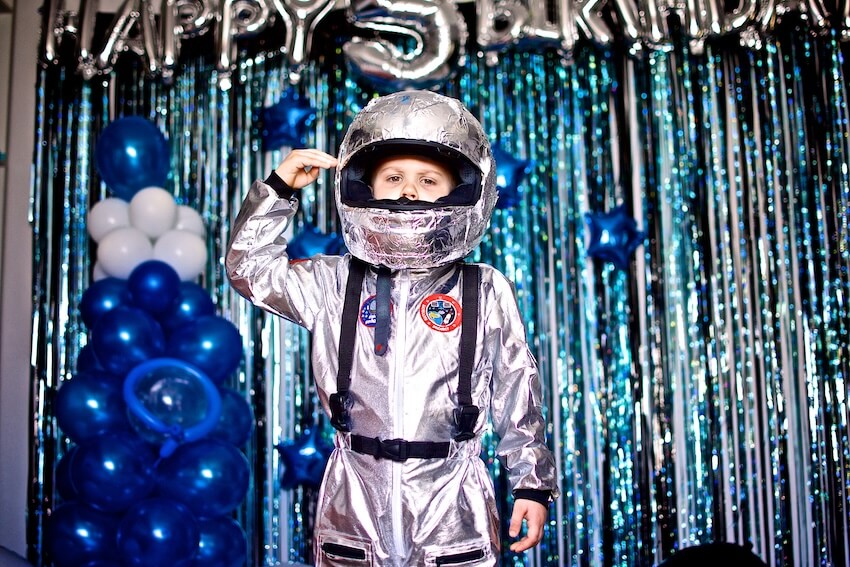 5 year old birthday party ideas: boy wearing an astronaut costume