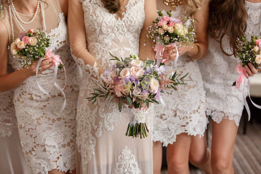 Budget rustic wedding ideas: bride and bridesmaids holding bouquets of flowers