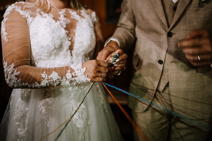 Bride and groom doing the handfasting ceremony