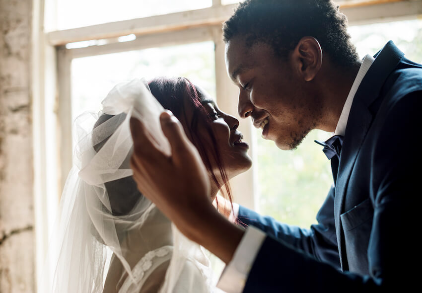 Fairytale wedding theme: bride and groom kissing each other