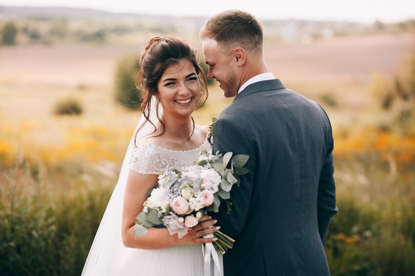 Affordable wedding invitations: bride and groom posing at the camera