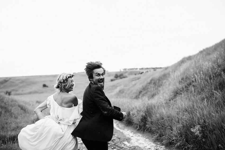Bride and groom running together
