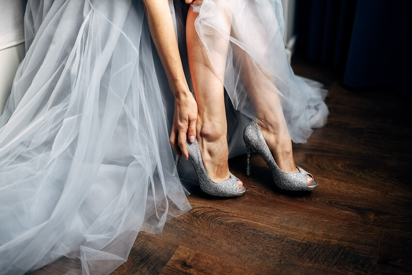 Non white wedding dresses: bride wearing a pair of silver heels