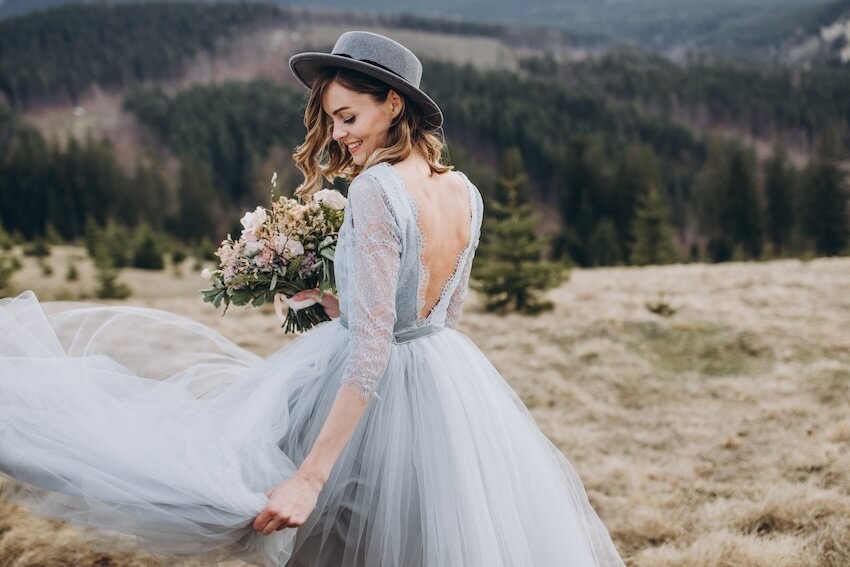 Non white wedding dresses: bride wearing a pastel blue colored gown