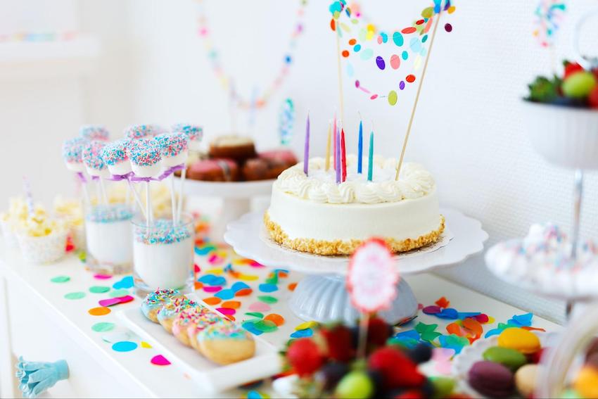 Ice cream birthday party: cake and varieties of sweet treats on a table