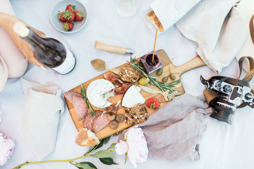 Aesthetic picnic: charcuterie board and a bottle of wine