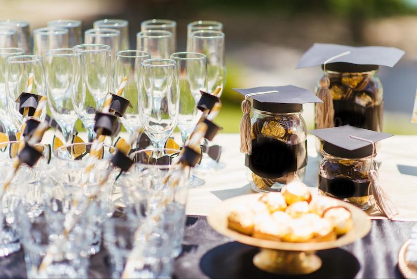 Graduation decoration ideas: chocolates and champagne glasses on a table