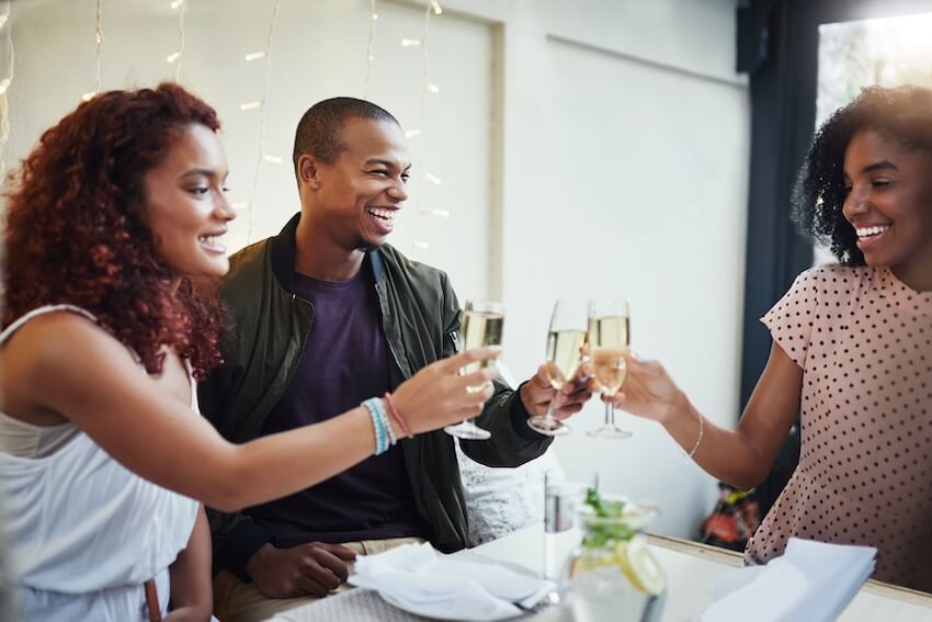 Engagement party invitations: couple and a woman clinking their glasses