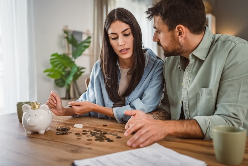 Wedding budget breakdown: couple counting their savings