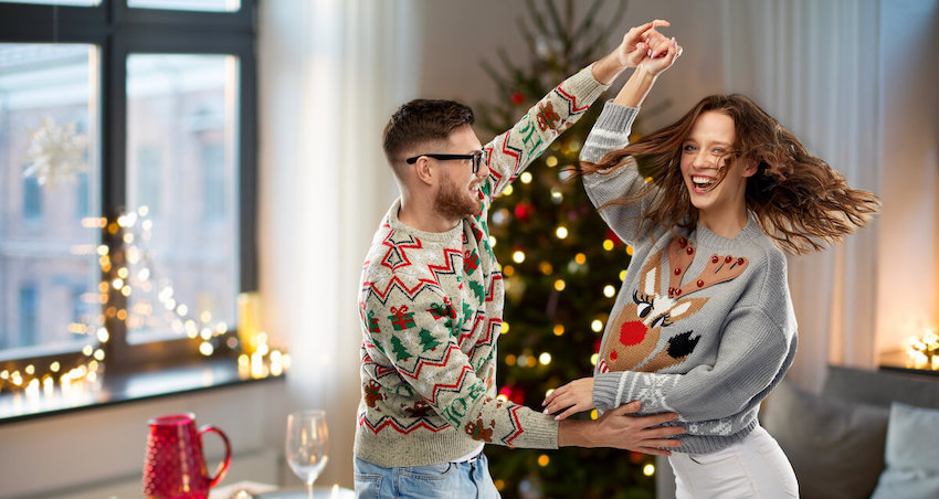 Ugly sweater party ideas: couple dancing at home