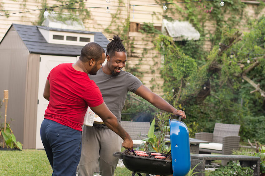 Summer BBQ: couple grilling outside