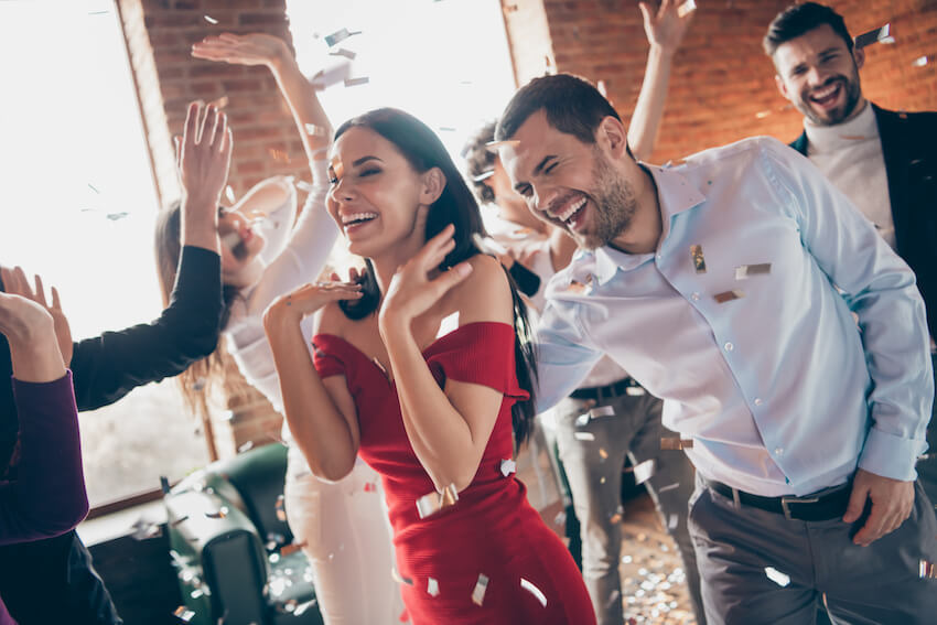 Wedding shower invitations: couple happily dancing with their friends