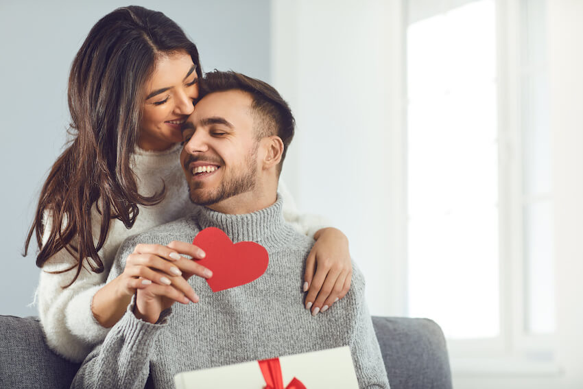 Valentines Day ideas: couple happily giving gifts to each other