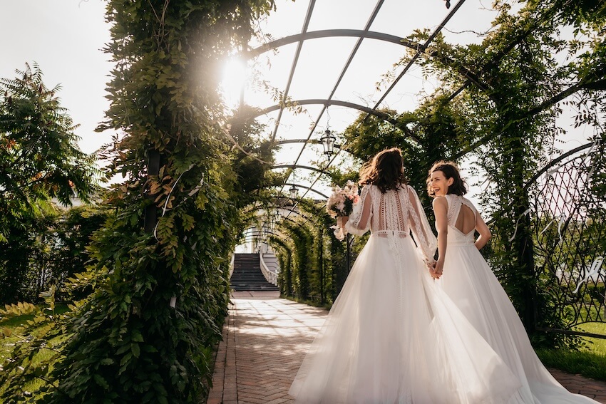 Couple happily walking together in a walkway trellis