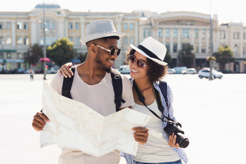 How to ask for honeymoon money instead of gifts: couple holding a map while walking