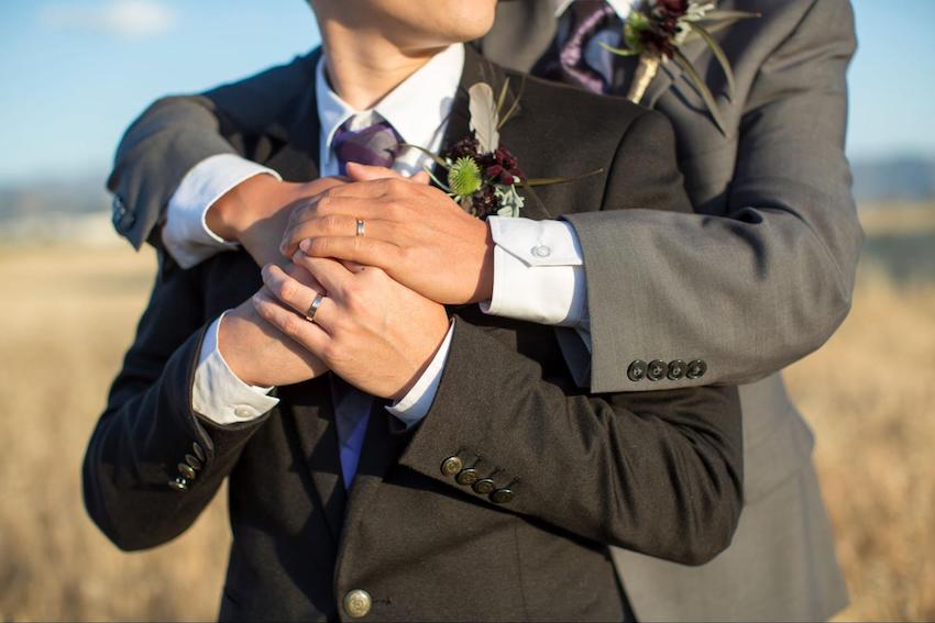 National park wedding: couple holding hands while hugging each other