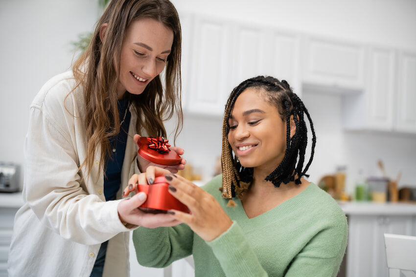 Valentine’s Day gift ideas: couple opening a gift