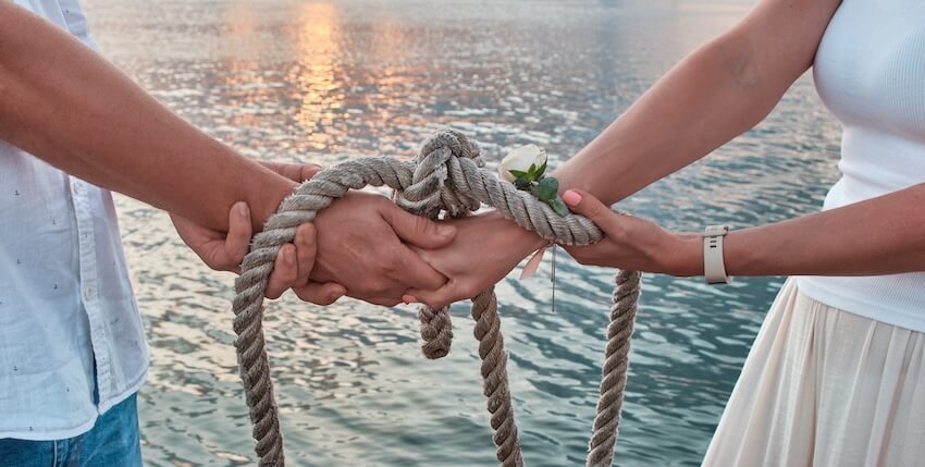 Couple using a rope to tie their hands together