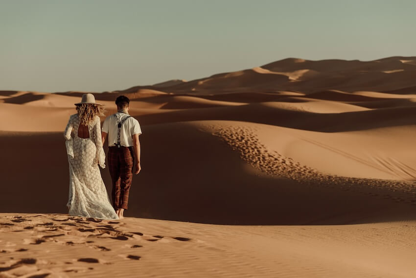 Couple walking in the middle of a desert