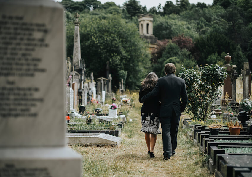 Condolence message to a friend: couple walking through a cemetery