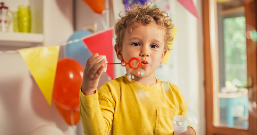 Cute boy blowing some bubbles