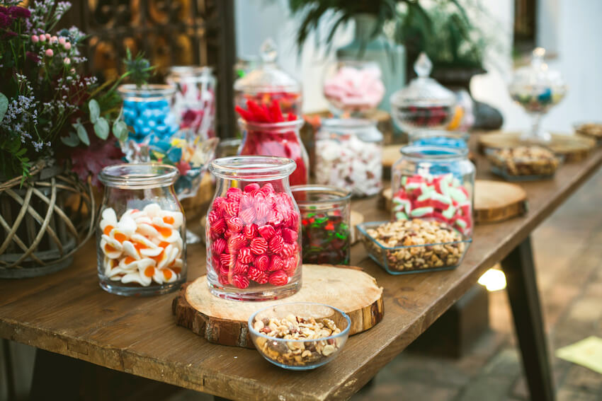 Graduation decoration ideas: dessert table with various jars of candies