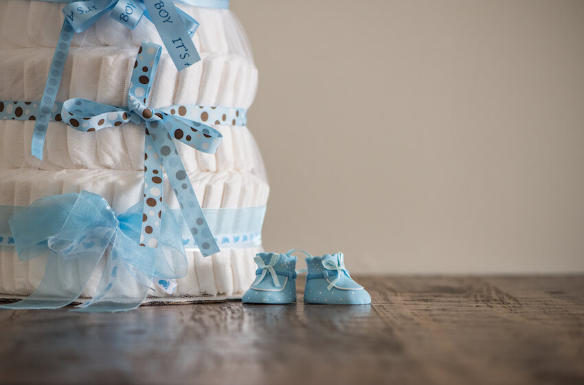 Diaper party: diaper cake and a pair of baby shoes