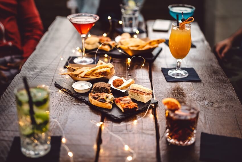 Different drinks and appetizers on a table