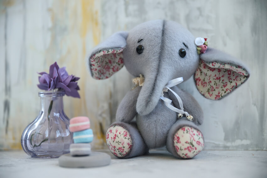 Elephant baby shower: elephant stuffed toy and a purple flower