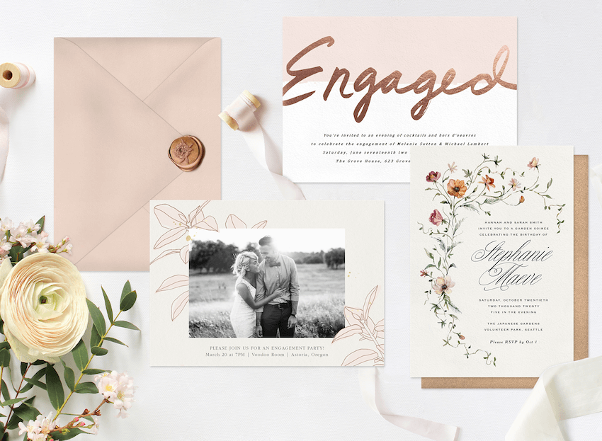 Three engagement party invitations laid out with a wax-sealed envelope, greenery, and ribbon